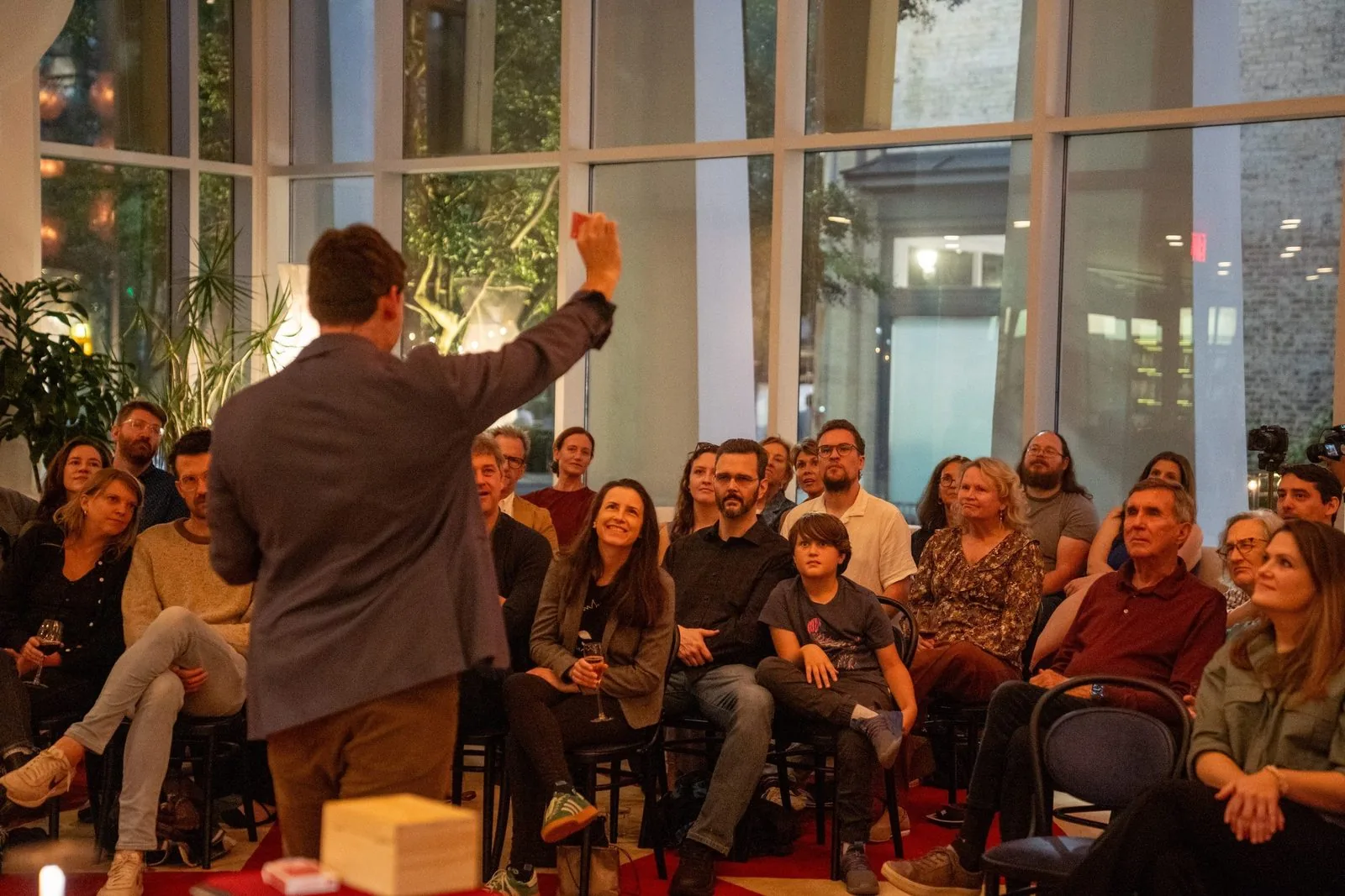 Michael Bloemeke performing on stage to a large seated audience.